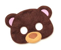 a brown teddy bear mask with pink ears