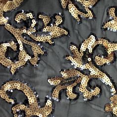 A flat sample of applique stretch mesh sequin with gold sequin on black mesh. Silver Embroidery, Baroque Design, Sequin Appliques, Sequins Embroidery, 00 00, Blue Moon, Cotton Lights, Color Card, Fabric Store