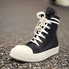 Step up your footwear game with the sleek style of Rick Owens Fashion Canvas Men Shoes. These shoes epitomize Rick Owens' vision, seamlessly blending fashion and comfort. Whether you're in search of black HI tops, genuine leather sneakers, lace-up casual shoes, or canvas footwear, these shoes are an excellent choice. Key Features: Fashion Element: These shoes feature a zipper fashion element, adding a touch of edginess to your style. Fit: These shoes fit true to size, offering a comfortable fit that embraces your feet's natural contours. Take your normal size for the perfect fit. Pattern Type: With a solid pattern, these shoes are versatile and effortlessly complement various outfits. Season: Ideal for both spring and autumn, these shoes adapt to changing weather conditions while enhancing Black High-top Lace-up Sneakers With Rubber Sole, Black Leather High-top Sneakers With Laces, Black Lace-up High-top Sneakers With Rubber Sole, Black Mid-top Boots With Vulcanized Sole, Black High-top Boots With Vulcanized Sole, Black High-top Sneakers With Platform And Round Toe, Black Ankle-high Boots With Vulcanized Sole, Ankle-high Black Boots With Vulcanized Sole, Black Boots With Contrast Sole For Streetwear