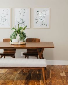 a wooden table with two chairs and a bench in front of it on a hard wood floor