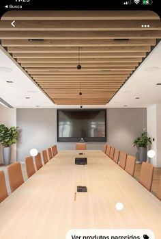 an empty conference room with wooden tables and chairs