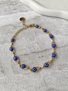 🧿 Stunning handmade Blue Evil eye jewellery, crafted from tarnish resistant stainless steel 🧿 The evil eye is a protective and powerful symbol, also known as the Nazar. The evil eye helps to absorb negative energies, protect and bring luck. The evil eye makes a perfect gift for yourself and loved ones.  Hand of Fatima Necklace https://www.etsy.com/uk/listing/1556603231/hamsa-hand-of-fatima-gold-pendant?click_key=a6f5da90d8d8ea8bd774c20becf761f1cd89bc53%3A1556603231&click_sum=a9a084e9&ref=shop_home_active_3 Hand of Fatima Earrings https://www.etsy.com/uk/listing/1542499652/hamsa-hand-of-fatima-gold-stud-earrings?click_key=89cabcb8ef68040716616f6d3e33732975d65ab1%3A1542499652&click_sum=5e820e7d&ref=shop_home_active_1 💎Jewellery Care💎 To ensure the longevity of your jewellery please avoid Nazar Eye Necklace, Metal Evil Eye Jewelry, Spiritual Round Evil Eye Bracelet, Adjustable Metal Evil Eye Jewelry, Metal Evil Eye Bracelet, Blue Symbolic Evil Eye Jewelry, Handmade Metal Evil Eye Bracelet, Evil Eye Metal Bracelet, Blue Metal Spiritual Bracelets