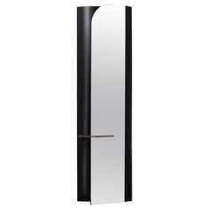 a tall black and white cabinet with a mirror on it