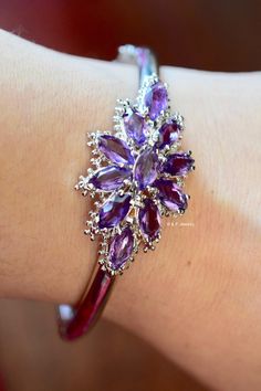 Metal: 14kt White Gold Weight Of Bangle Including Gems: 18.80 grams Stone: Amethyst Shape: Marquise-shape Amethyst Weight: Approximately 6.05 ctw Closer Type: Box Clasp With Safety Chain Width of Center Part Of Bangle: 21.28 mm Length of Center Part Of Bangle: 39.81 mm Bangle Width: 4.80 mm Inner Diameter: 2 1/4 in. Approximately Fits A 7 inch Wrist. Luxury Single Strand Amethyst Jewelry, Fine Amethyst Jewelry, Amethyst Bracelet In Fine Jewelry Style, Purple Polished Finish Jewelry For Wedding, Purple Jewelry With Polished Finish For Wedding, Formal Purple Jewelry With Polished Finish, Elegant Purple Jewelry With Polished Finish, Purple Marquise Jewelry For Formal Occasions, Purple Polished Jewelry For Wedding