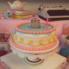 a cake that is sitting on top of a table in front of a typewriter