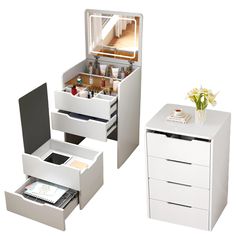 two white drawers are open and one drawer is closed, the other has its contents in it