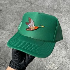 Introducing our laid-back essential, a green 5-Panel High Crown Mesh Back Trucker Hat - the epitome of casual comfort and easygoing style. Crafted for leisurely days, this hat features a high crown design and breathable mesh panels, making it your effortless go-to for a relaxed vibe. What sets this cap apart? A personalized ironed Duck patch on the front. Add a touch of uniqueness that reflects your individuality and style. Whether you're strolling through the city or embracing the great outdoors, the 5-Panel High Crown Mesh Back Trucker Hat keeps you cool and fashionable. Would you like to customize your now hat/patch? Just reach out. Green Trucker Hat For Outdoor, Green Adjustable Flat Brim Snapback Hat, Green Trucker Baseball Cap With Flat Brim, Green Trucker Cap With Flat Brim, Green Snapback Hat With Curved Brim For Outdoor, Green Snapback Hat With Short Brim For Outdoor, Green Outdoor Hats For Spring, Adjustable Green Snapback Hat, Green Hats For Spring Outdoor Activities