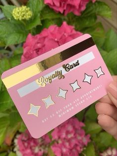 a person holding up a pink card with stars on it and the words enjoy band