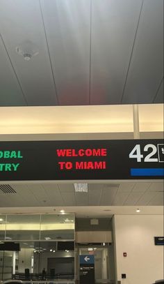 there is a sign that says welcome to miami and global entry on the front of an airport