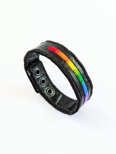 A chic and subtle pride wristband. Features a really cool ombre-effect rainbow embroidery and personalized initials (optional). Base material is made from heat-fused trash bags. Measures 16cm to 20cm with 3 snap buttons for an adjustable fit. This will fit most people. If you fall outside of this range, let me know and we can figure something out! Check out the rest of my Pride section: https://www.etsy.com/shop/theKANG?section_id=48254278 Browse my main store: https://www.etsy.com/shop/theKANG Initials Embroidery, Fused Plastic, Wristband Design, Rainbow Embroidery, Ombre Effect, Trash Bags, Wrist Cuffs, Personalized Initials, Cuff Bracelets