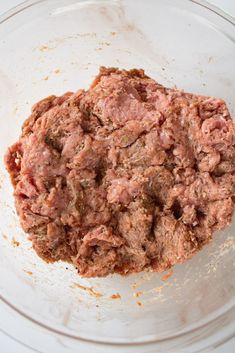 an uncooked meat mixture in a glass bowl