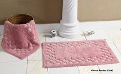 a pink rug next to a basket on the floor