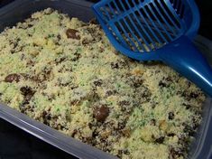 a plastic container filled with food next to a blue grater