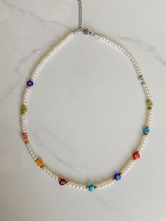 This gorgeous beaded necklace is made with a variety of millefiori beads, and pearl beads! Necklace measures 15 inches long! If you have any questions or concerns please feel free to message me and I'll try my best to get back to you ASAP Happy shopping!! White Pearl Beaded Necklaces With Letter Beads, White Pearl Necklaces With 8mm Beads, White Pearl Necklaces With Colorful Beads, Pearl Necklace With Letter Beads And Round Beads, White Pearl Beaded Necklace With Letter Beads, Bohemian Pearl Necklaces With Letter Beads, Pearl Beaded Necklaces With Letter Beads, Colorful Beads Pearl Necklace Gift, Bohemian Pearl Necklace With Letter Beads