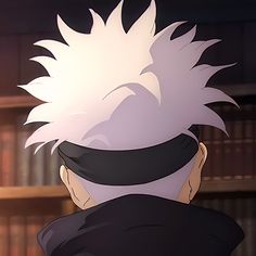 the back of a man with white hair in front of bookshelves