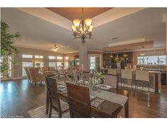 a dining room and living room with hardwood floors