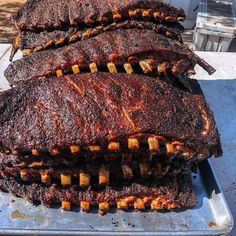 some ribs are sitting on top of a metal pan and ready to be grilled