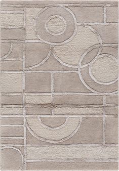 a white rug with circles and squares on top of the rug is in front of a brick wall