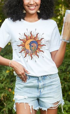 Celestial Sun & Moon Short Sleeve Tee. This classic unisex jersey short sleeve tee fits like a well-loved favorite. Soft cotton and quality print make users fall in love with it over and over again. These t-shirts have-ribbed knit collars to bolster shaping. The shoulders have taping for better fit over time. Dual side seams hold the garment's shape for longer.  .: 100% Airlume combed and ringspun cotton (fiber content may vary for different colors) .: Light fabric (4.2 oz/yd² (142 g/m .: Retail fit .: Tear away label .: Runs true to size Celestial Sun, Sun Moon, Jersey Shorts, Cotton Fiber, Fall In Love, Light Fabric, Ribbed Knit, Short Sleeve Tee, Print Quality