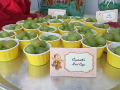 there are many small cups with green apples in them on the table, along with a card that says congratulations