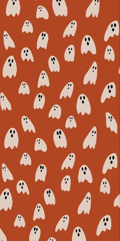 an orange background with white ghost faces