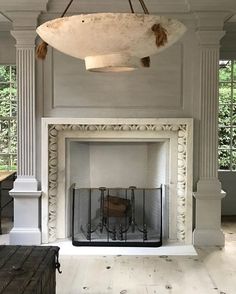 a large white fireplace in a living room