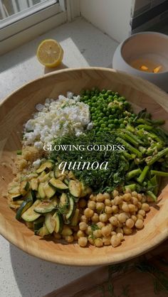 a wooden bowl filled with different types of food