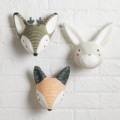 three animal masks are hanging on the wall