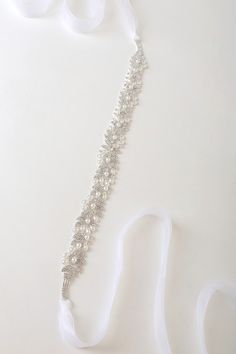 The Lulus Sweetest Ending Silver Rhinestone and Pearl Bridal Belt is the perfect touch for your special day! Look absolutely gorgeous with this belt that features sparkling, clear glass rhinestones (in silver settings) along with shiny faux pearls that shape an abstract design. Sheer ribbons tie together at the back for an elegant finish. 88" Long. Embellishment Measures 16" Long And 1" Wide . 50% Glass, 35% Copper, 10% Pearl, 5% Nylon. Imported. Lulus | Sweetest Ending Silver Rhinestone and Pea Untamed Petals, Bridal Halo, Bridal Hairdo, Veil Headpiece, Wedding Sash Belt, Gold Belts, Vancouver Wedding, Wedding Costs, Rhinestone Belt