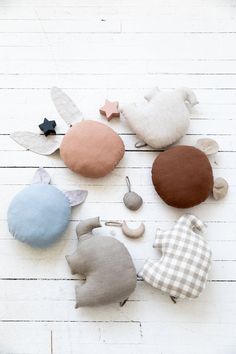 several different colored stuffed animals on a white wooden surface