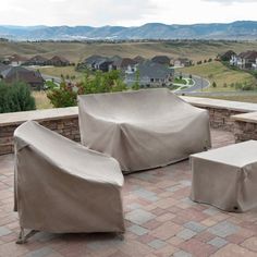 an outdoor patio with chairs and covers on it