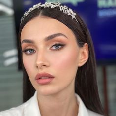 a woman with long hair wearing a tiara