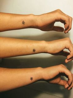 two people with matching tattoos on their arms