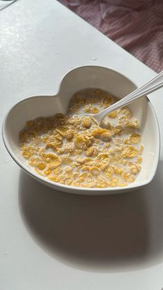 cereal in a heart shaped bowl on a table