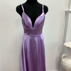 Brand New , Never Been Worn Dress . This Beautiful Lavender Gown Is Long And Body Forming But Flows On The Bottom , It Has Straps On The Back For Added Detail And Padding In The Front For Extra Comfort. This High Quality Satin Material Is So Soft And Feels Great On The Body . Makes For A Beautiful Evening Gown For An Outing Or For Any Special Event . Purple V-neck Homecoming Dress, Lavender V-neck Dress For Formal Occasions, Sleeveless Lavender Maxi Dress For Prom, Lavender Dress For Spring Homecoming, Lavender A-line Prom Dress, Lavender V-neck Bridesmaid Dress, Purple Satin Sleeveless Maxi Dress, Sleeveless Purple Satin Maxi Dress, Lavender Homecoming Dresses For Summer