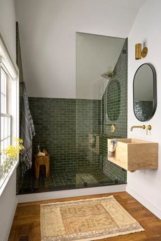 a bath room with a sink a mirror and a rug