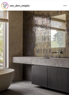 a bath room with a large mirror and a big tub in the middle of it