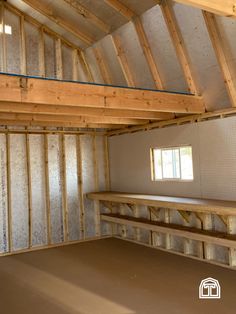 an empty room with wooden beams and walls