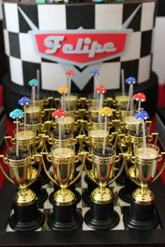 the trophies are lined up on top of each other in front of a checkerboard background