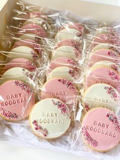 a box filled with baby shower cookies covered in frosting