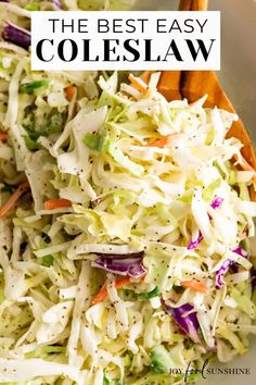 a white bowl filled with coleslaw slaw and wooden spoon in the bowl