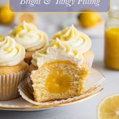 cupcakes with white frosting and lemon on a plate