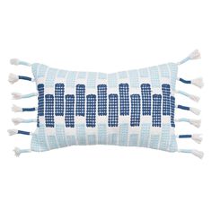 a blue and white pillow with tassels on it