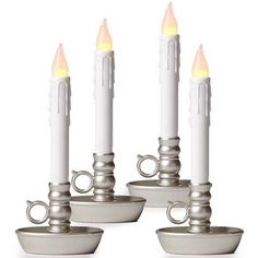 four white candles sitting on top of each other