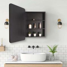 a bathroom with white tile and wooden cabinet above the sink, along with potted plants