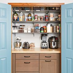 a kitchen with blue doors and shelves filled with food