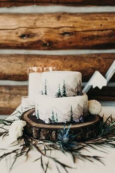 two white cakes sitting on top of a wooden table