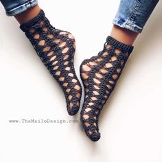 woman's feet wearing black crochet sandals with holes on the toes and ankles