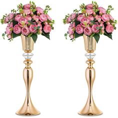 two gold vases with pink flowers on them