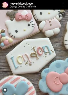 hello kitty cookies are arranged on a table with the word lolopop spelled in cursive letters